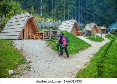 A tourist couple checking out wooden huts at a glamping site at Lake Bloke, Nova Vas, Slovenia - Shutterstock ID 1766312333