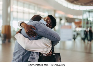 Tourist Couple Giving Warm Goodbye Hug At Airport Departure Gate. Wife Getting Good Bye Hug From Her Husband At Airport.