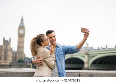 Tourist Couple Taking Selfie At Big Ben, London