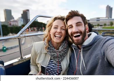 tourist couple travel selfie on open top tour bus in city - Powered by Shutterstock