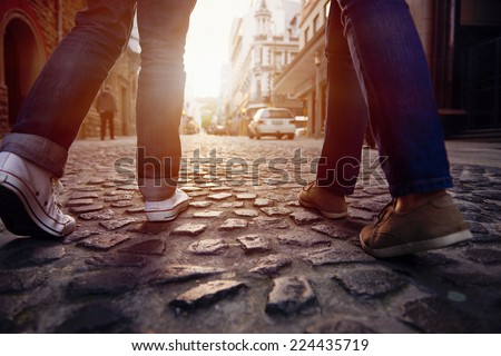 tourist couple walking on cobblestone street vacation in europe on holiday break