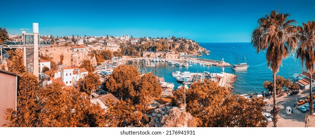 Tourist Cruise Ship Or Yacht Is Sailing To Antalya Old Town Harbor From Open Sea. Trip And Excursion And Vacation In Turkey Background