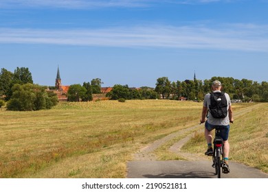 Tourist cycling along the green belt near Domitz former inner-German border and death strip between East and West Germany during the cold war. Nowadays a major biosphere park in Germany.
