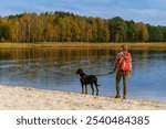 Tourist with a dog exploring Stawy Echo (Echo Ponds), a part of Roztoczanski National Park, Poland