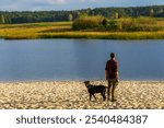 Tourist with a dog exploring Stawy Echo (Echo Ponds), a part of Roztoczanski National Park, Poland