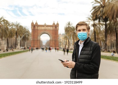 Tourist In Empty City Street. Tourism During Pandemic. Man Walking And Wearing Medical Face Masks Outdoors Next To Blue Steps. Travel Bans Countries Set Limits For Travel Face Masks Mandatory