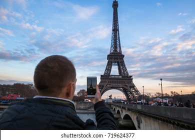 Tourist enjoy view on Eiffel Tower from street. Winter in Paris, France