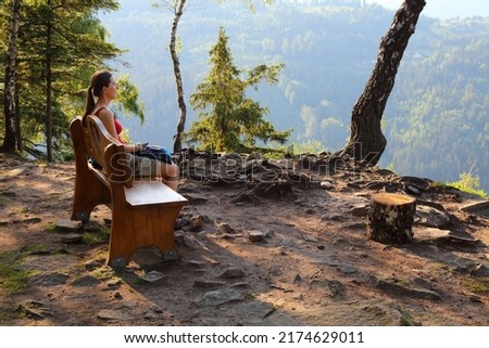 Tourist enjoys the view in Silesian Beskids, Poland. Krzakoska Skala viewpoint.