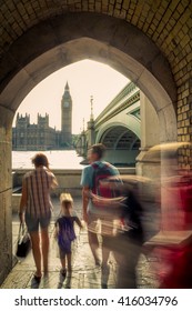 Tourist Family Exploring London With Big Ben And Westminster Bridge In Background 