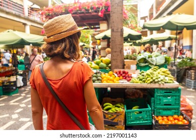 A tourist at the famous Farmers Market in Madeira's city of Funchal. Portugal - Powered by Shutterstock