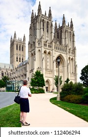 Tourist Gazing At The Nondenominational National Cathedral Of The United States Prior To Earthquake Damage In 2011. Important Traditional Venue For State Ceremonies. Known For Its Gothic Architecture.