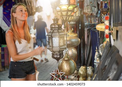 Tourist Girl Shopping In Moroccan Souk Of Marrakech