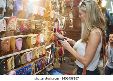 Tourist Girl Shopping In Moroccan Souk Of Marrakech