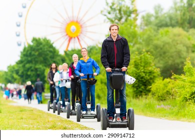 Tourist Group Having Guided Segway Theme Park Tour