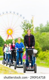 Tourist Group Having Guided Segway Theme Park Tour