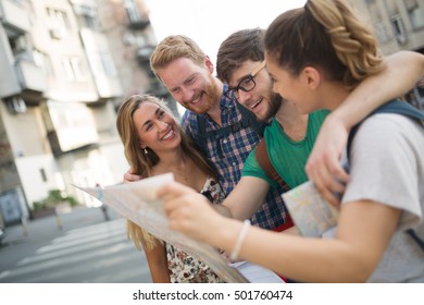 Tourist Group Led By Tour Guide On Their Travel