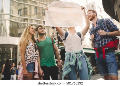 Tourist Group Led By Tour Guide On Their Travel