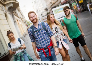 Tourist Group Led By Tour Guide On Their Travel