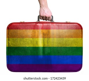 Tourist Hand Holding Vintage Leather Travel Bag With Flag Of LGBT