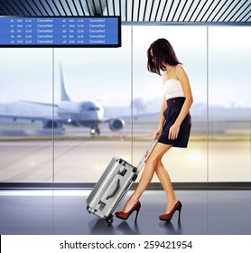 tourist info signage in airport and beautiful passenger with luggage