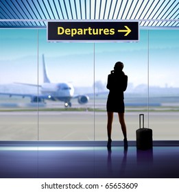 Tourist Info Signage In Airport And Silhouette Of Passenger