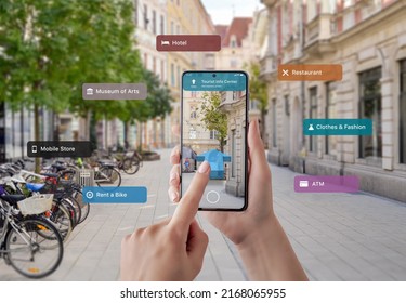 Tourist information and signposts on smart phone in tourist hands. The concept of using augmented reality apps and technology in tourism