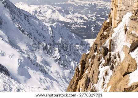 Tourist infrastructure and mountain interpretation elements sit beside glaciers and steep alpine rock.