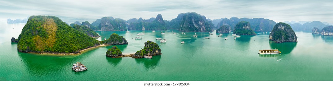 Tourist junks floating among limestone rocks at early morning in Ha Long Bay, South China Sea, Vietnam, Southeast Asia. Ten vertical images panorama
