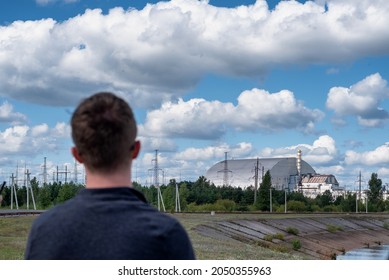 A Tourist Looking At The Exploded Chernobyl Nuclear Reactor 