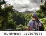 Tourist looking at the La Fortuna Waterfall in Costa Rica. The waterfall is located on the Arenal River at the base of the dormant Chato volcano.