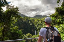 Tourist Looking At The La Fortuna Waterfall In Costa Rica. The Waterfall Is Located On The Arenal River At The Base Of The Dormant Chato Volcano.