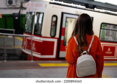 Tourist Looking At The Nostalgic Tram. Tram And Woman. Nostalgic Tram Istanbul.