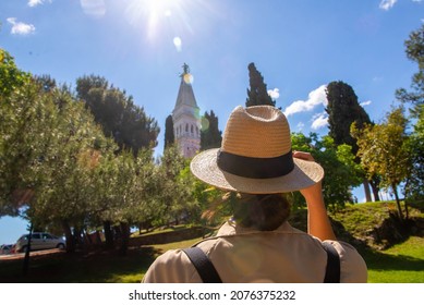 Tourist looking up at St Euphemia church on hilltop in Rovinj, Istria