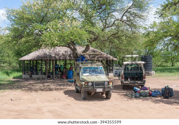 Tourist luggage and car in safari campsite\
(camp-lodge) in savanna. Serengeti National Park, Great Rift\
Valley, Tanzania, Africa.\
\
