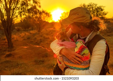 Tourist Man Holding Orphaned Baby Kangaroo At Sunset Sunlight In Australian Outback. Interacting With Cute Kangaroo Orphan. Australian Marsupial In Northern Territory, Central Australia, Red Centre.