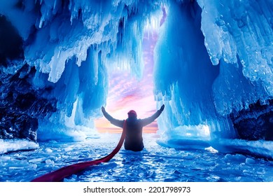 Tourist Man In Mysterious Blue Ice Cave Or Grotto On Frozen Lake Baikal. Concept Adventure Surreal Winter Landscape With People.