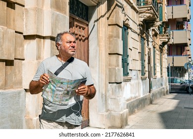 Tourist Man On The Street Looking Map Wondering Where He Should Go. Urban Traveling Leisure. Travel Guide, Tourism In Europe.