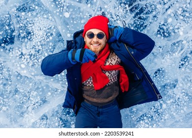 Tourist Man With Red Scarf Background Ice With Gas Methane Bubbles Lake Baikal. Adventure Winter Travel Photo.