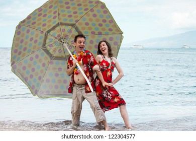 Tourist In Matching Outfits Dancing With An Umbrella In Hawaii