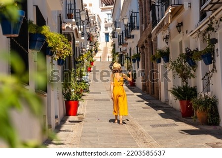 A tourist in Mijas visiting the white houses and charming town and the slopes in Malaga. Andalusia
