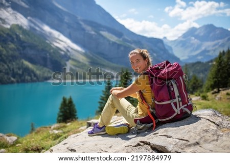 Tourist in the mountains in Switzerland on Lake Oeschinensee