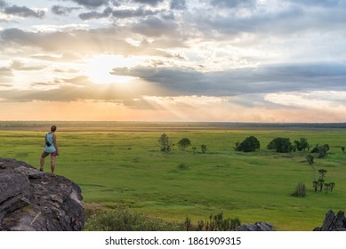 Tourist at Nadab lookout during sunset, Ubirr Walk, Kakadu National Park, Nothern Territory, Australia