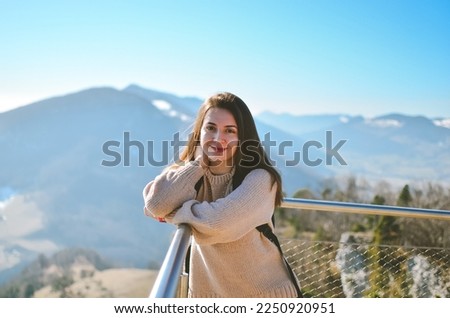 Tourist on the observation deck.Observation deck in Switzerland.Woman tourist in the mountains.Viewpoint in the mountains.Green mountains.A woman walks in the mountains.Beautiful posing of a tourist.