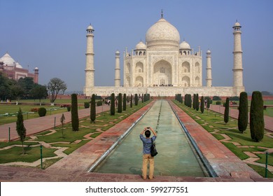 Tourist photographing Taj Mahal in Agra, Uttar Pradesh, India. It was build in 1632 by Emperor Shah Jahan as a memorial for his second wife Mumtaz Mahal.
