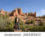 Tourist posing for photos at Bryce Canyon National park. Utah. USA. 