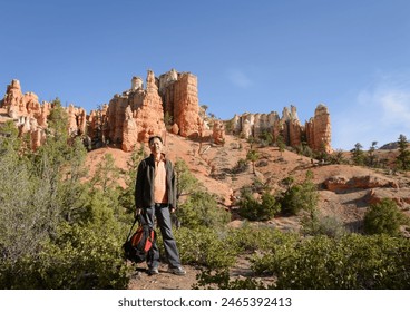 Tourist posing for photos at Bryce Canyon National park. Utah. USA. 