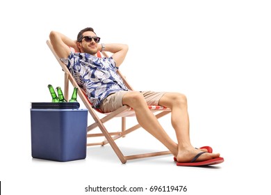 Tourist relaxing in a deck chair next to a cooling box filled with bottles of beer isolated on white background - Powered by Shutterstock