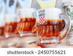 Tourist resort souvenir beer glass bottle opener fridge magnets, featuring the Croation flag, for sale in Hvar, Croatia, Europe