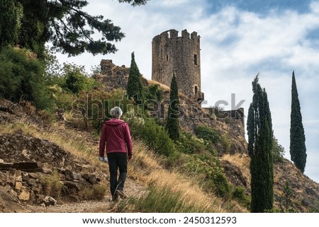 A tourist in the ruins of the medieval castle of Lastours, in the Cathar region of southern France