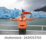 Tourist sailing on Grey Lake, observing the Grey Glacier, located in Chilean Patagonia, in the Southern Ice Fields, within Torres del Paine National Park.
